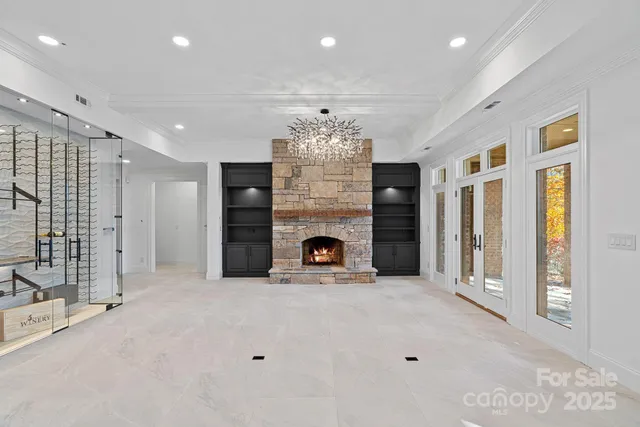 a view of kitchen with granite countertop cabinets and chandelier