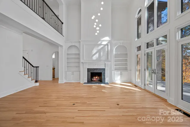 a view of an empty room with a fireplace and a window