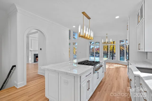 a kitchen with stainless steel appliances granite countertop a stove and a sink