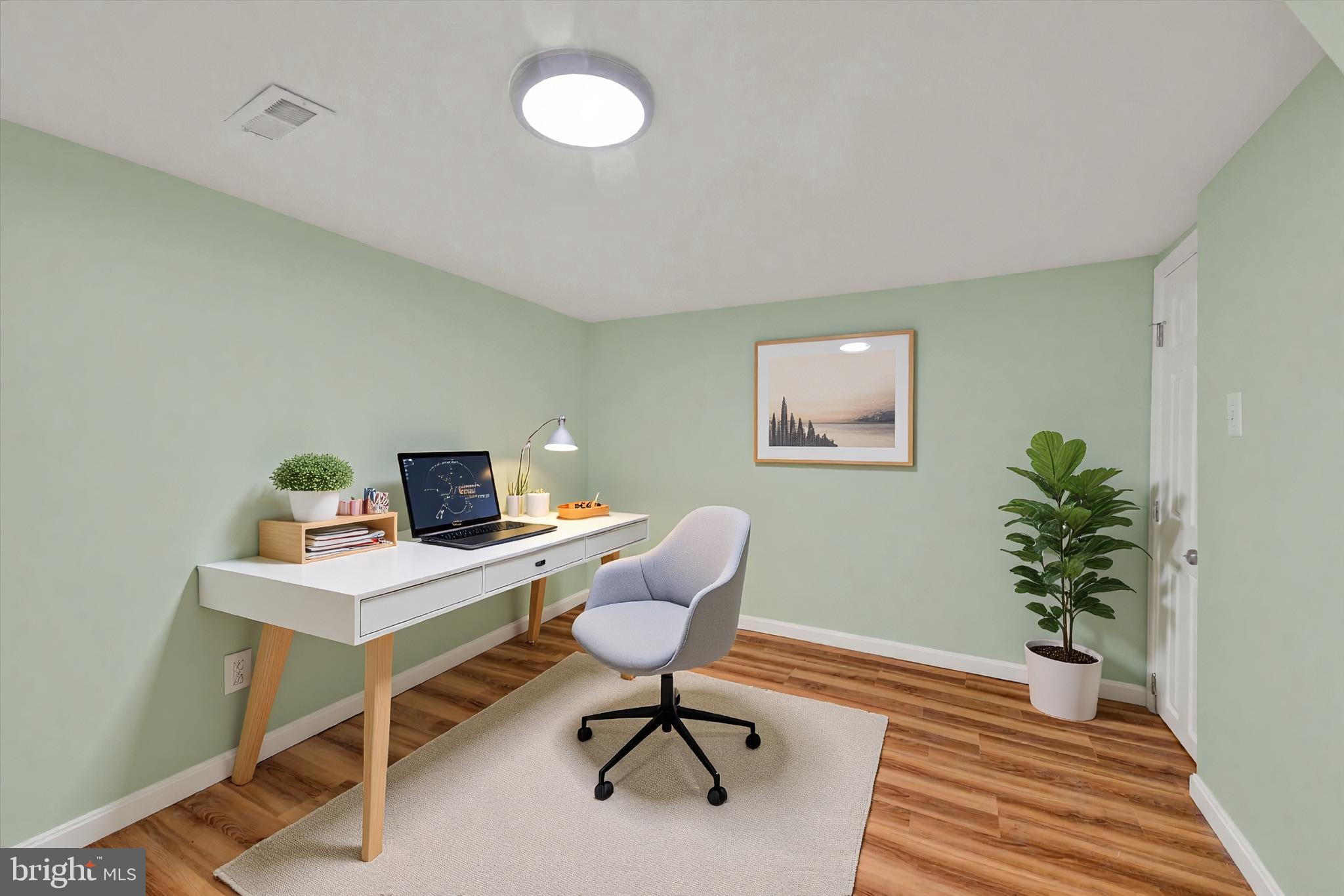 8511 Frederick Road Ellicott City, MD 21043 - Photo 14 of 36 a workspace with furniture and wooden floor