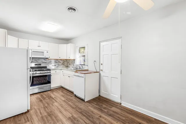a kitchen with a white cabinets and white appliances