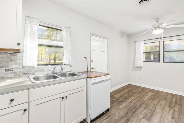 a kitchen with a sink cabinets and window