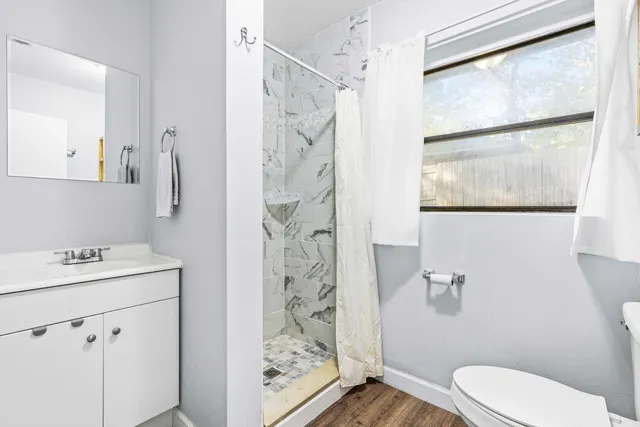a bathroom with a sink toilet and shower