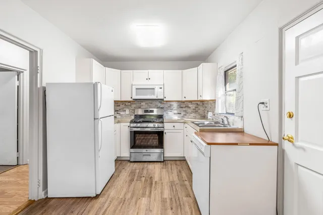 a kitchen with a refrigerator stove and sink
