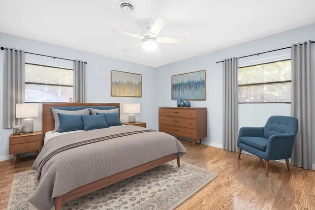 a bedroom with a bed a couch and dresser