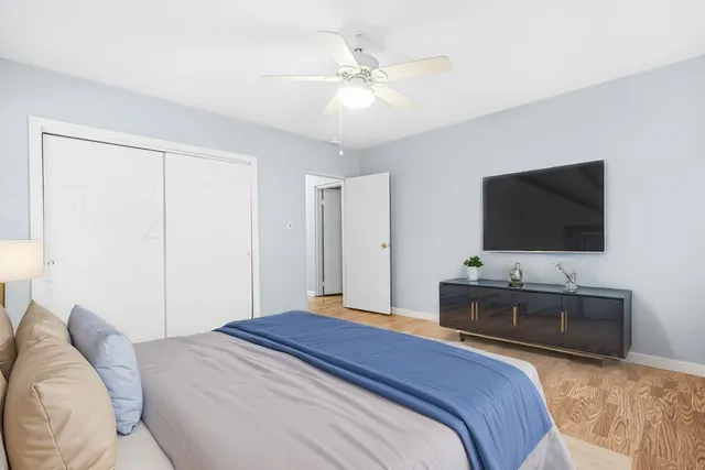 a bedroom with a bed and a flat screen tv