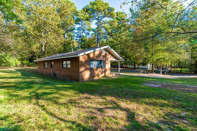 a front view of house with yard and green space