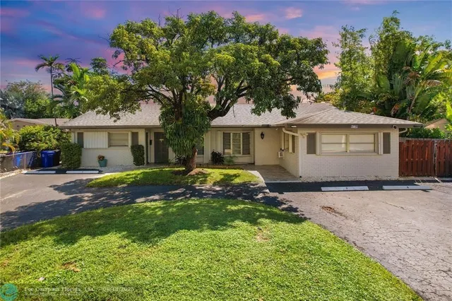 a view of a house with a swimming pool and a yard