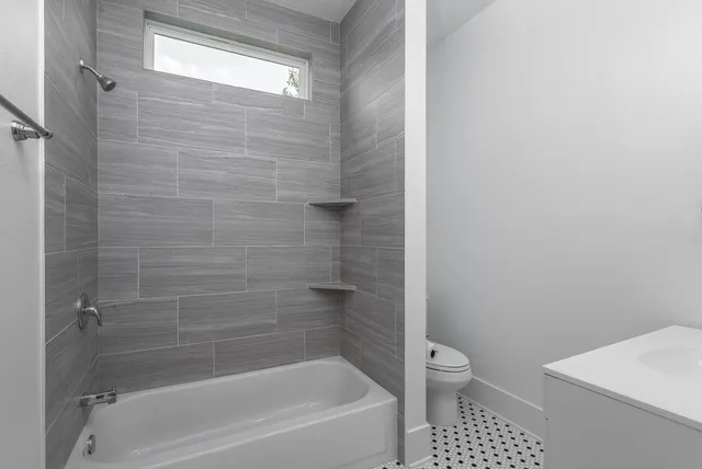 a bathroom with a bathtub and a toilet