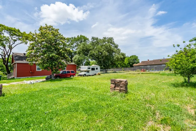 a garden with trees in the background