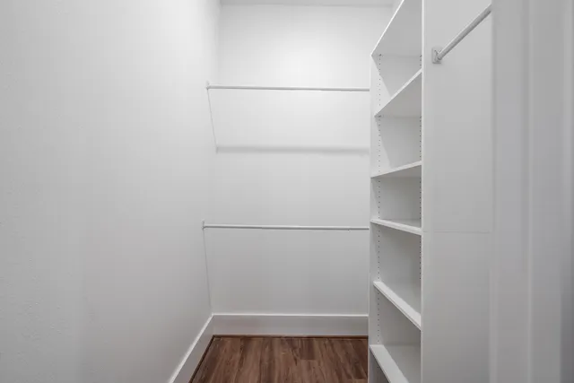 a view of walk in closet with empty racks