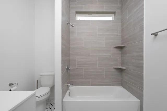 a bathroom with a bathtub and a toilet