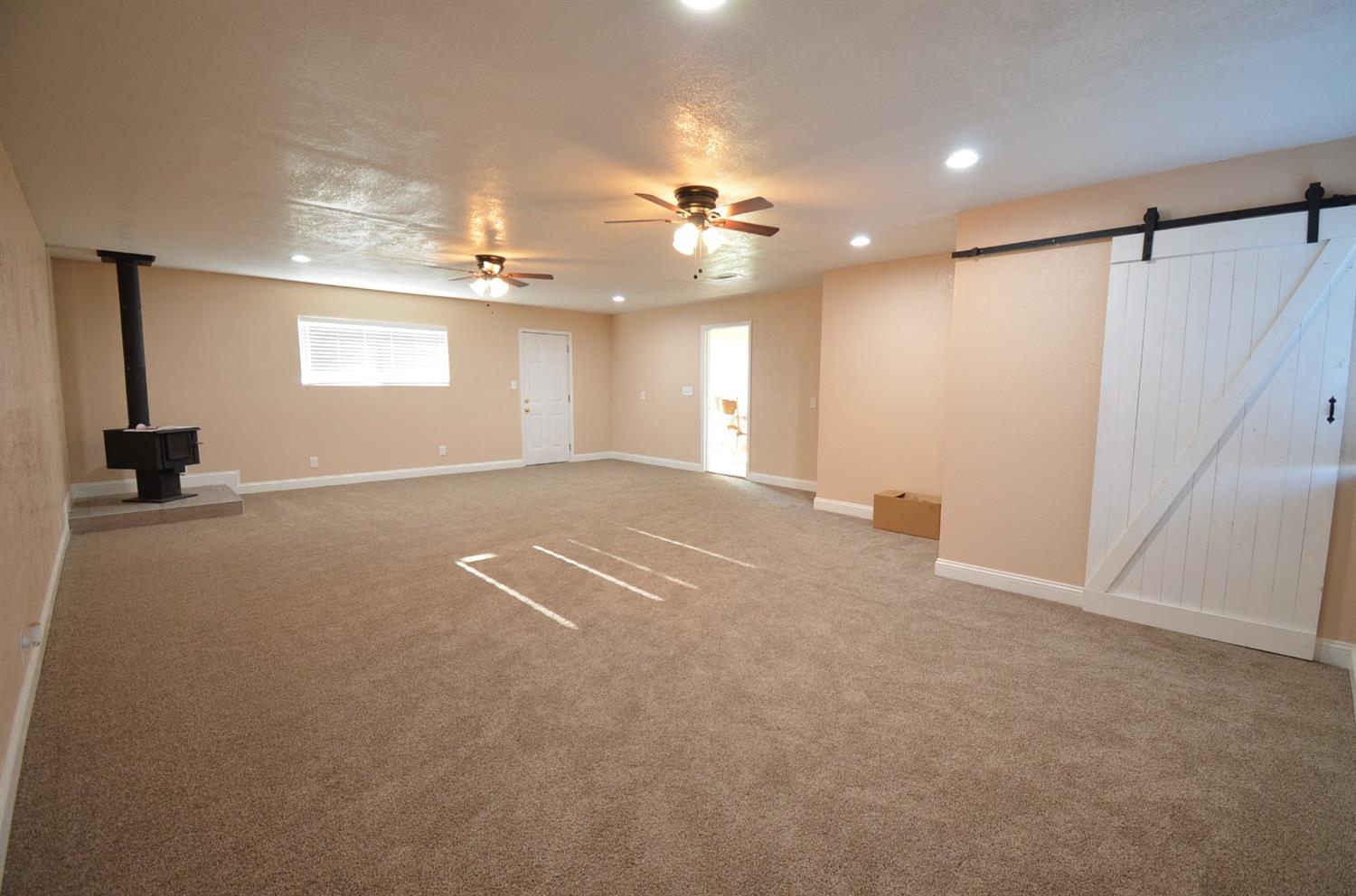 16936 Mark Road Madera, CA 93636 - Photo 3 of 27 Wood stove to keep this room warm, has a half bath and laundry...air B and B anyone??