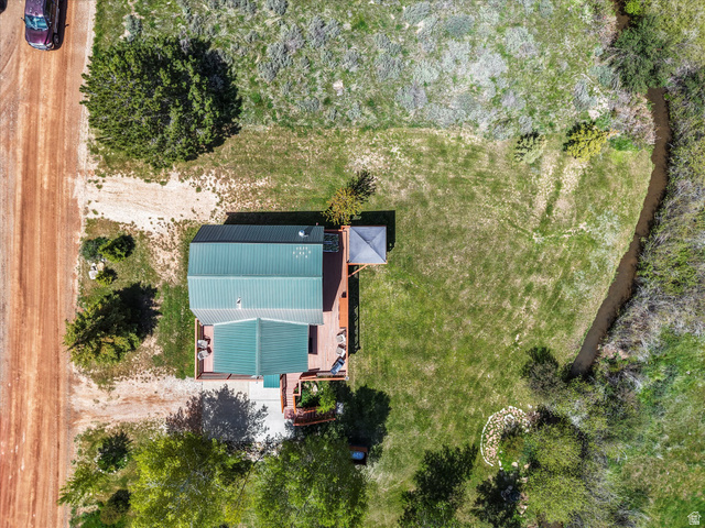 371 Lewis Loop, Unit 29 Fish Haven, ID 83287 - Photo 40 of 40 Aerial property overview featuring a dwelling with a green metal roof and extensive wood-finish decking
