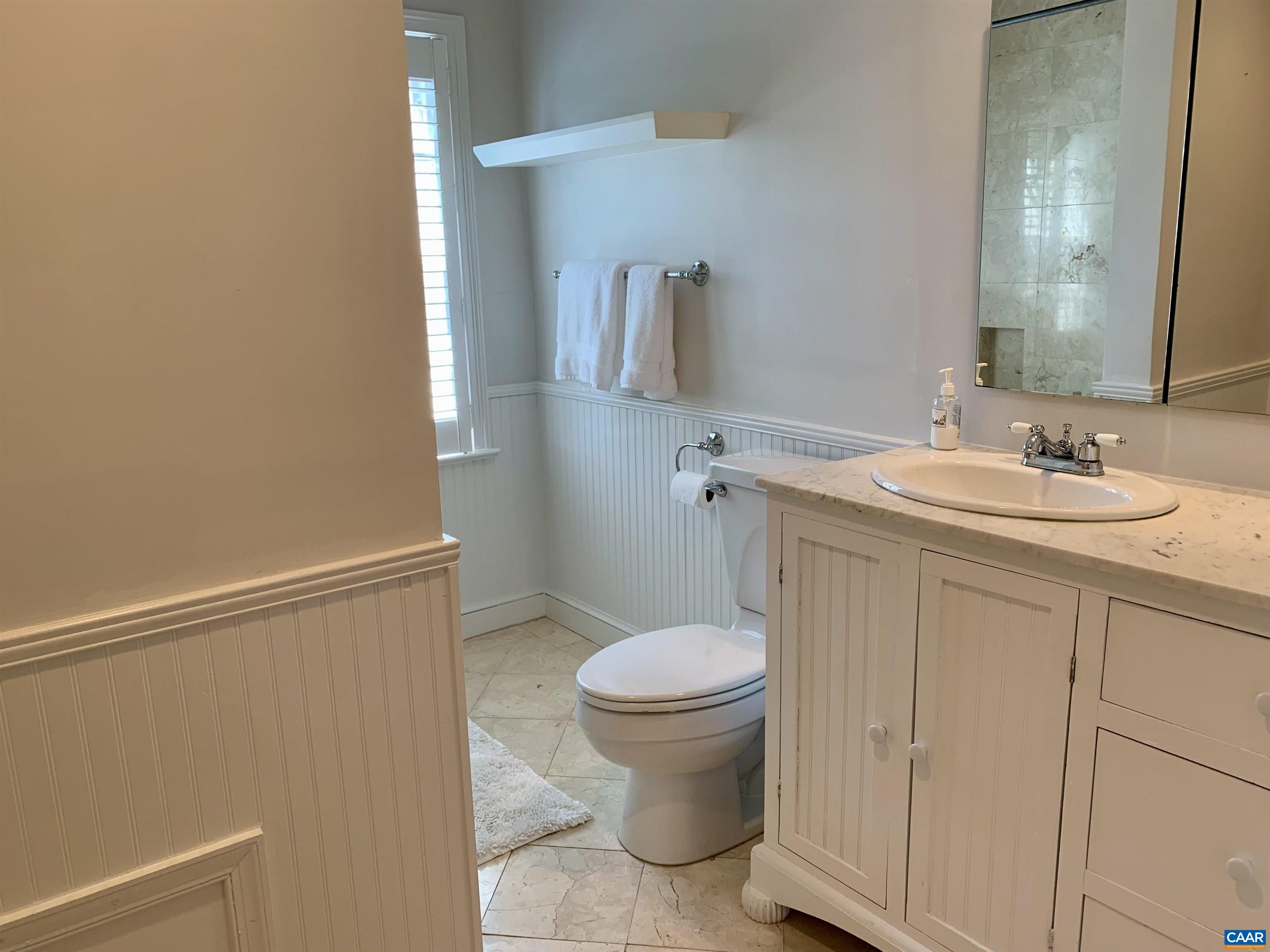 1882 Westview Road Charlottesville, VA 22903 - Photo 34 of 52 a bathroom with a granite countertop sink toilet and a mirror