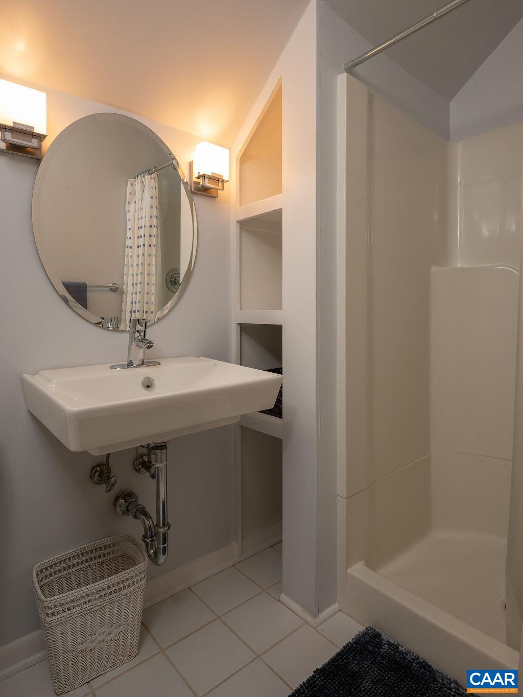1882 Westview Road Charlottesville, VA 22903 - Photo 39 of 52 a bathroom with a sink a mirror and a shower