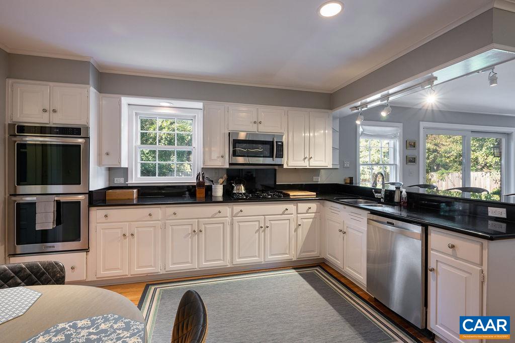 1882 Westview Road Charlottesville, VA 22903 - Photo 8 of 52 a kitchen with granite countertop a stove a sink and a microwave