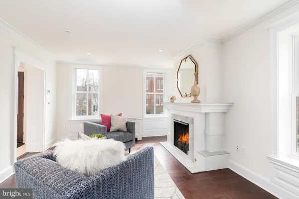 a bedroom with a bed large window and a fireplace