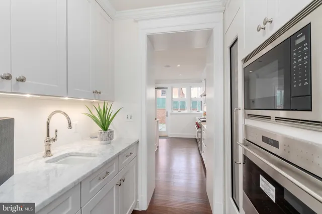 a en suite bathroom with a granite countertop sink and a mirror