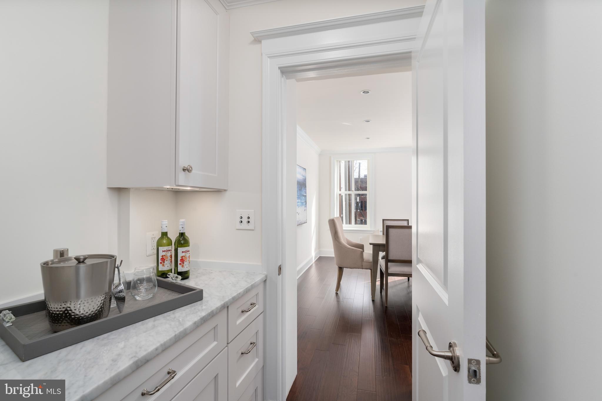 2715 N Street Northwest Washington, DC 20007 - Photo 28 of 41 a kitchen with a table and chairs