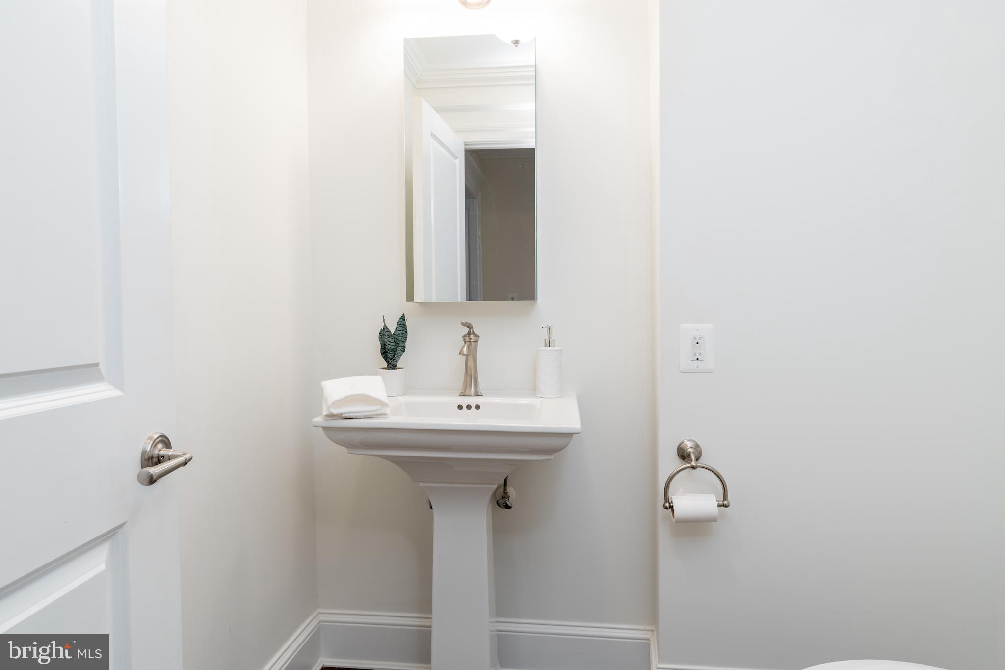 2715 N Street Northwest Washington, DC 20007 - Photo 34 of 41 a bathroom with a sink a mirror and toilet
