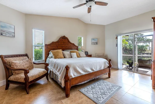 a bedroom with a bed chair and window