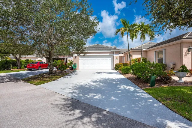 a front view of a house with a yard and a garage