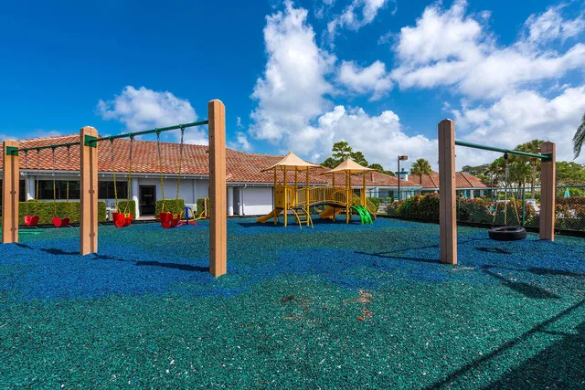 a view of an house with backyard and porch