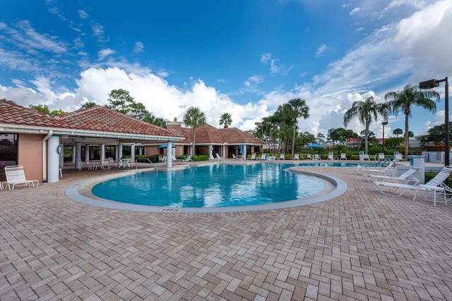 a view of a house with swimming pool and a yard