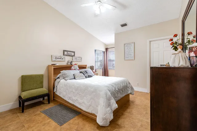 a bed room with a bed and a chair