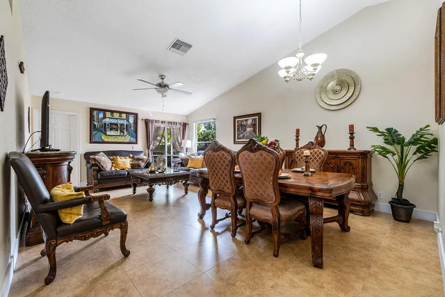 a view of a dining room with furniture and chandelier