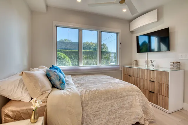 a bedroom with a bed and a flat screen tv
