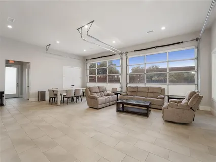 a living room with furniture and large glass door