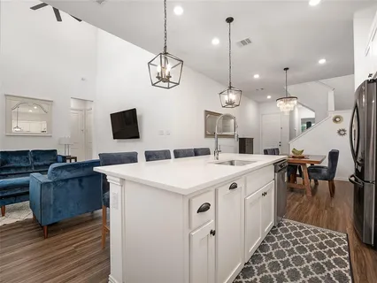 a large kitchen with a table and chairs