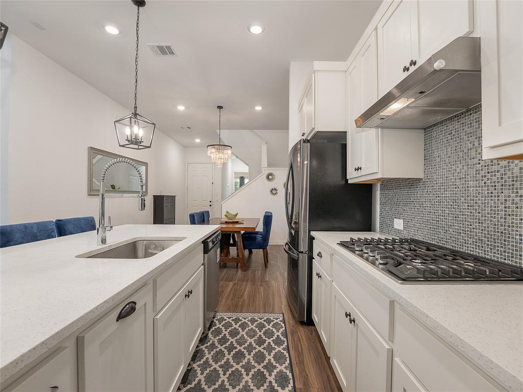 223 Woodson Street Irving, TX 75063 - Photo 17 of 40 a kitchen with a sink a stove a refrigerator and furniture