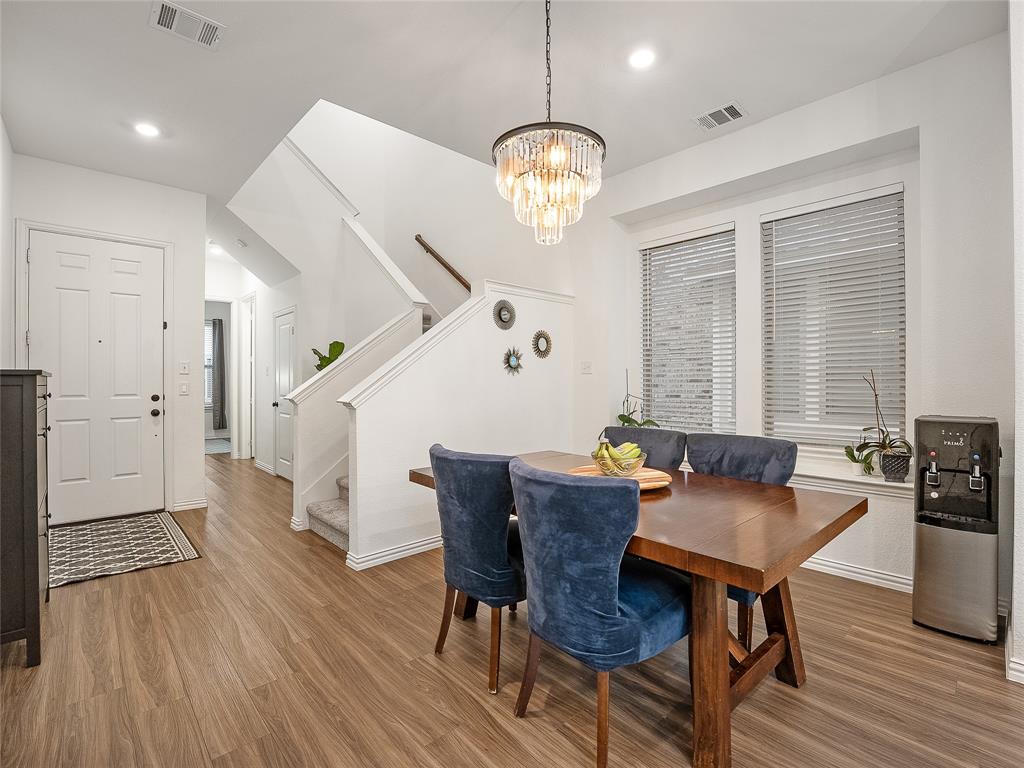 223 Woodson Street Irving, TX 75063 - Photo 20 of 40 a view of a dining room with furniture window and wooden floor