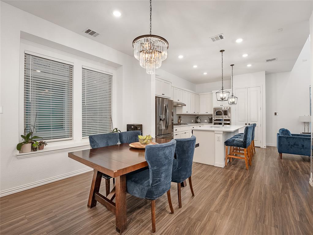 223 Woodson Street Irving, TX 75063 - Photo 21 of 40 a view of a dining room with furniture window and wooden floor