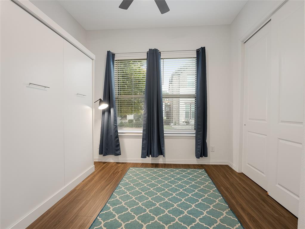 223 Woodson Street Irving, TX 75063 - Photo 22 of 40 a view of a room with wooden floor and windows
