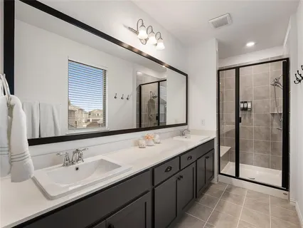 a bathroom with a double vanity sink mirror and double