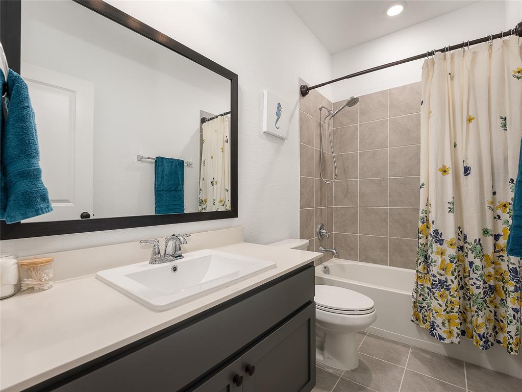 223 Woodson Street Irving, TX 75063 - Photo 31 of 40 a bathroom with a sink a toilet and shower