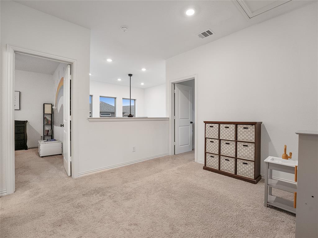 223 Woodson Street Irving, TX 75063 - Photo 32 of 40 a view of a kitchen with furniture and a refrigerator