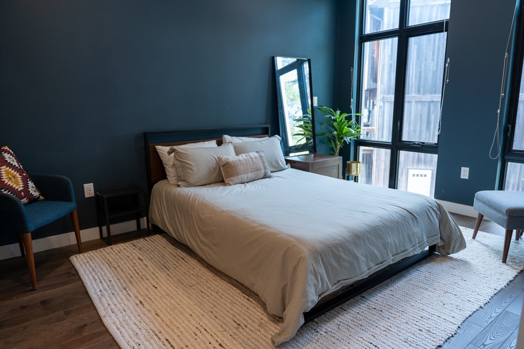 2 Sinclair Road, Unit 202 Boston, MA 02134 - Photo 10 of 23 a large bed sitting in a bedroom next to a window