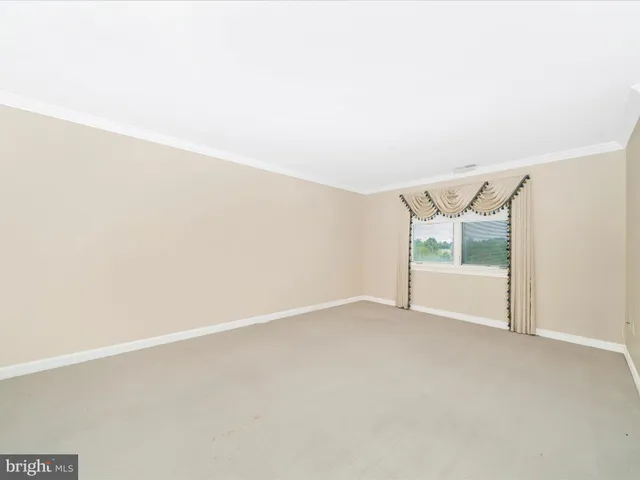 a view of a kitchen with granite countertop cabinets and refrigerator