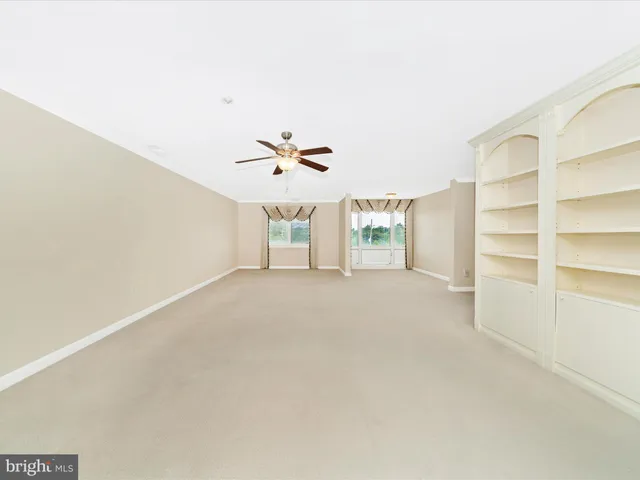 a view of a room with window view and wooden floor