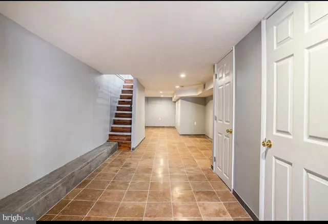 a view of an empty room with a staircase