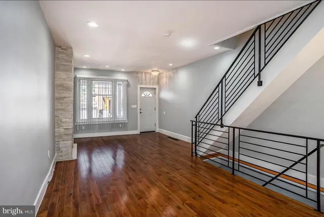 a view of entryway with wooden floor and stairs