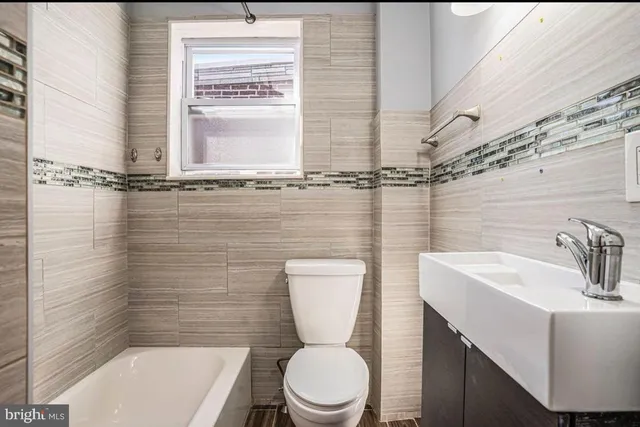 a bathroom with a toilet a sink and a bathtub