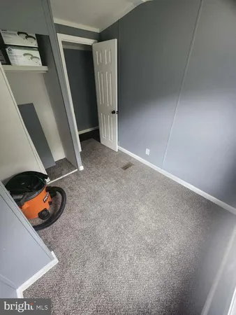 a kitchen with a stove wooden floor and a sink