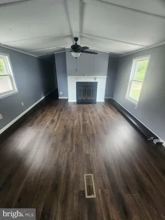 a view of a livingroom with a ceiling fan and window