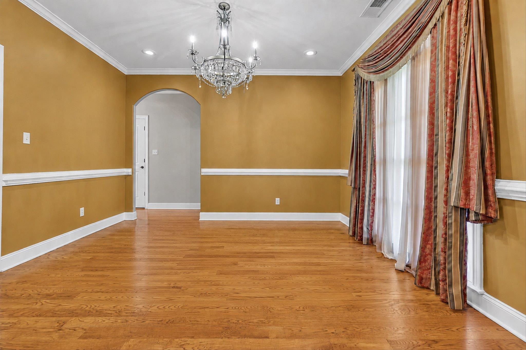 7284 Bucknell Road Millington, TN 38053 - Photo 5 of 35 Hardwood flooring, crown molding, chair rail molding, recessed lighting, and an arched doorway
